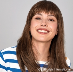 Portrait d'une femme portant la perruque Captive en cheveux de synthèse d'Elite Hair International